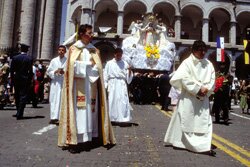 Priests are followed by policemen carrying a statue of Our Lady through the streets of Arequipa in Peru